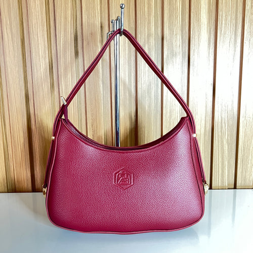 Burgundy pebbled leather crescent hobo shoulder bag front hanging view – Meraki by Emaan Pakistan