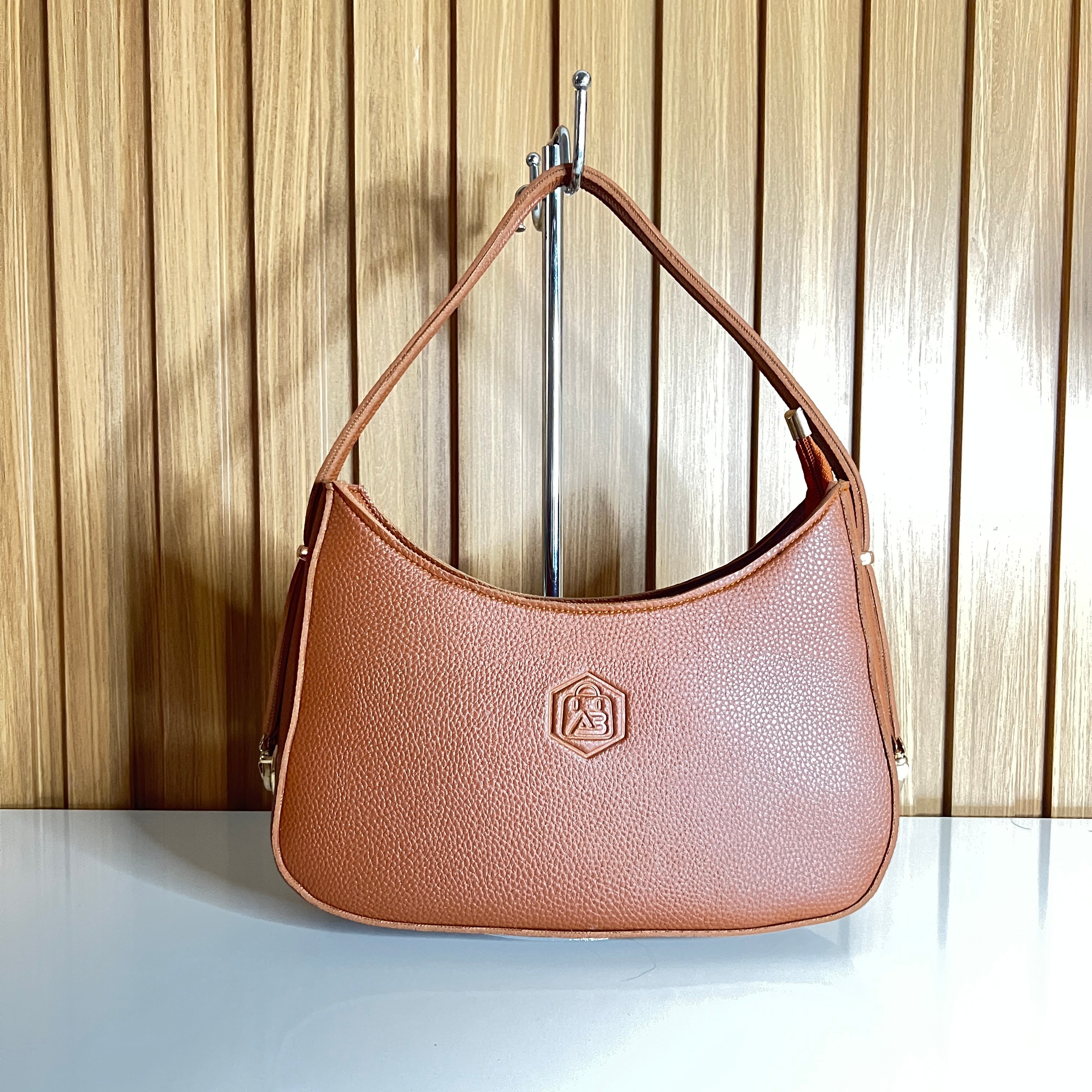 Camel tan crescent hobo bag hanging view – Meraki by Emaan Pakistan