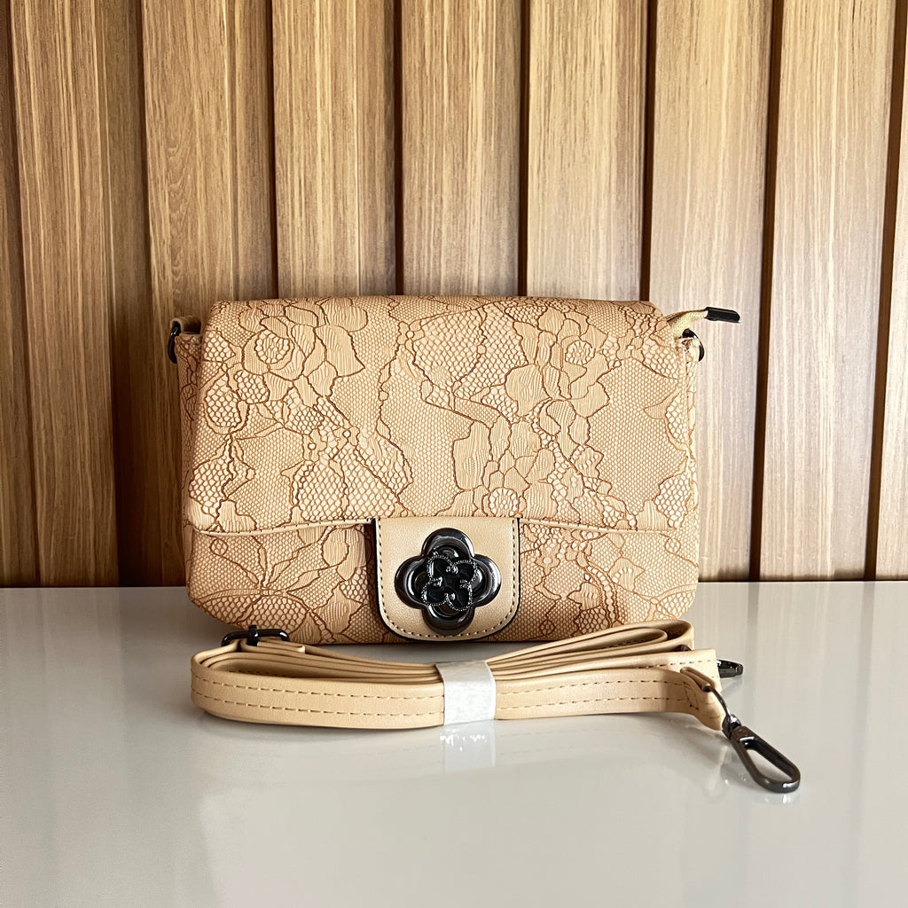 Cream floral lace-embossed crossbody bag front view with flower clasp and strap – Meraki by Emaan Pakistan