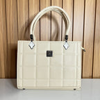 Cream quilted top handle bag front view with logo plaque – Meraki by Emaan Pakistan