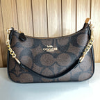 Logo Print Crescent Shoulder Bag – Brown & Black with Gold Chain Strap by Meraki by Emaan Pakistan - Front View with Mini Strap