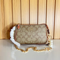Logo Print Mini Clutch with Pearl & Gold Chain Strap – Khaki & Saddle by Meraki by Emaan Pakistan- Front View