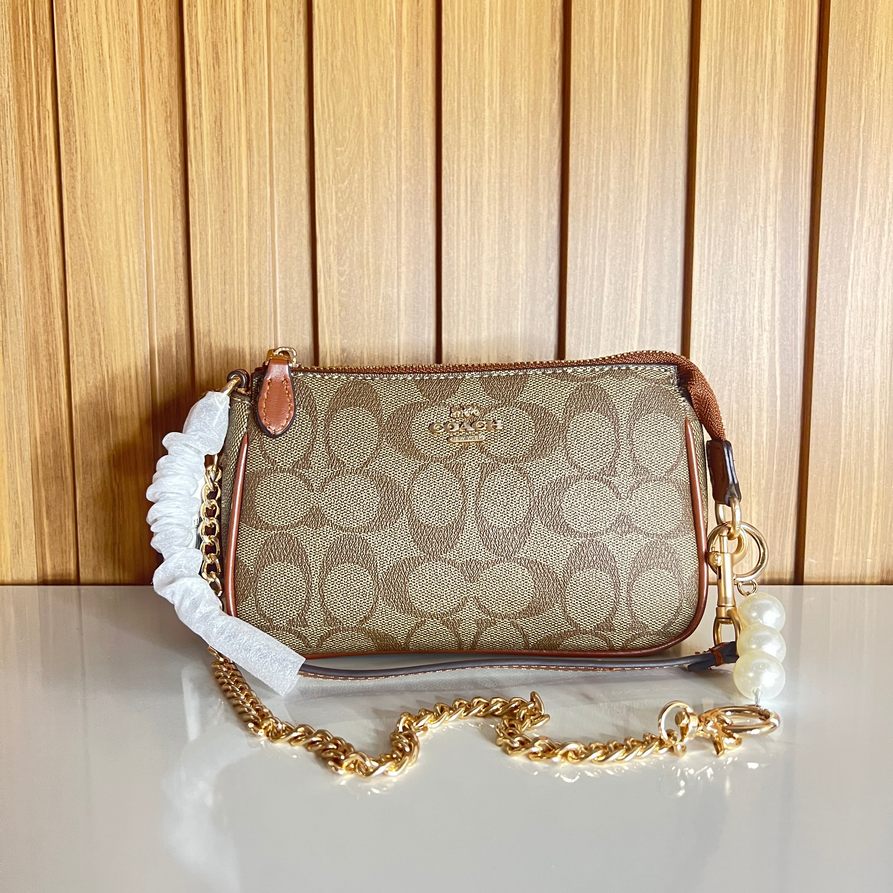 Logo Print Mini Clutch with Pearl & Gold Chain Strap – Khaki & Saddle by Meraki by Emaan Pakistan- Front View