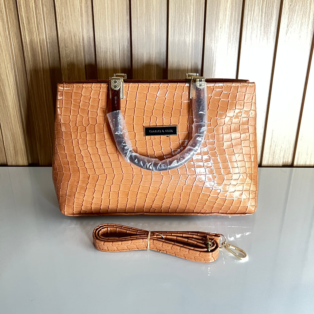 Peach croc-embossed structured handbag front view with crossbody strap – Meraki by Emaan Pakistan