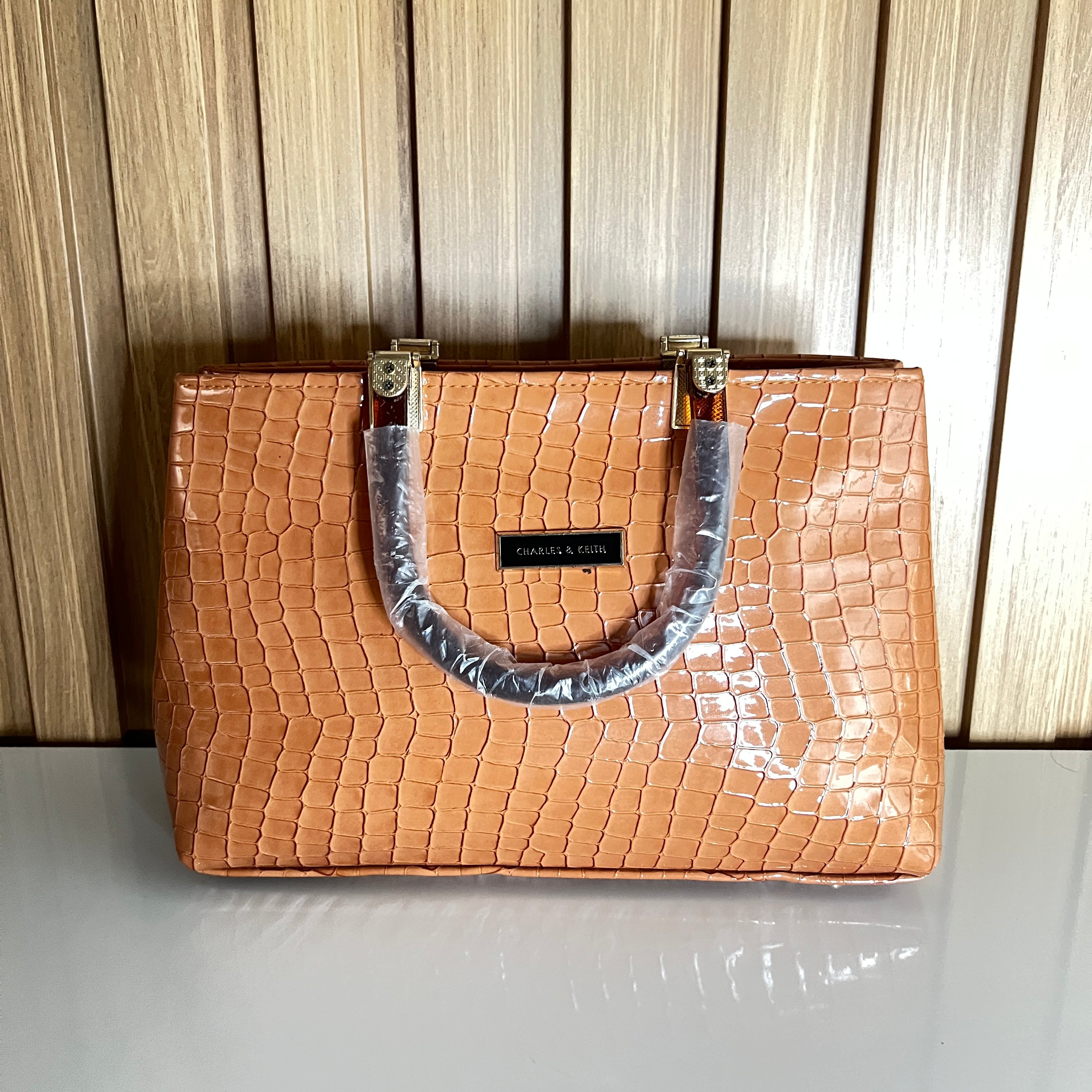 Peach croc handbag front view with black logo plaque – Meraki by Emaan Pakistan