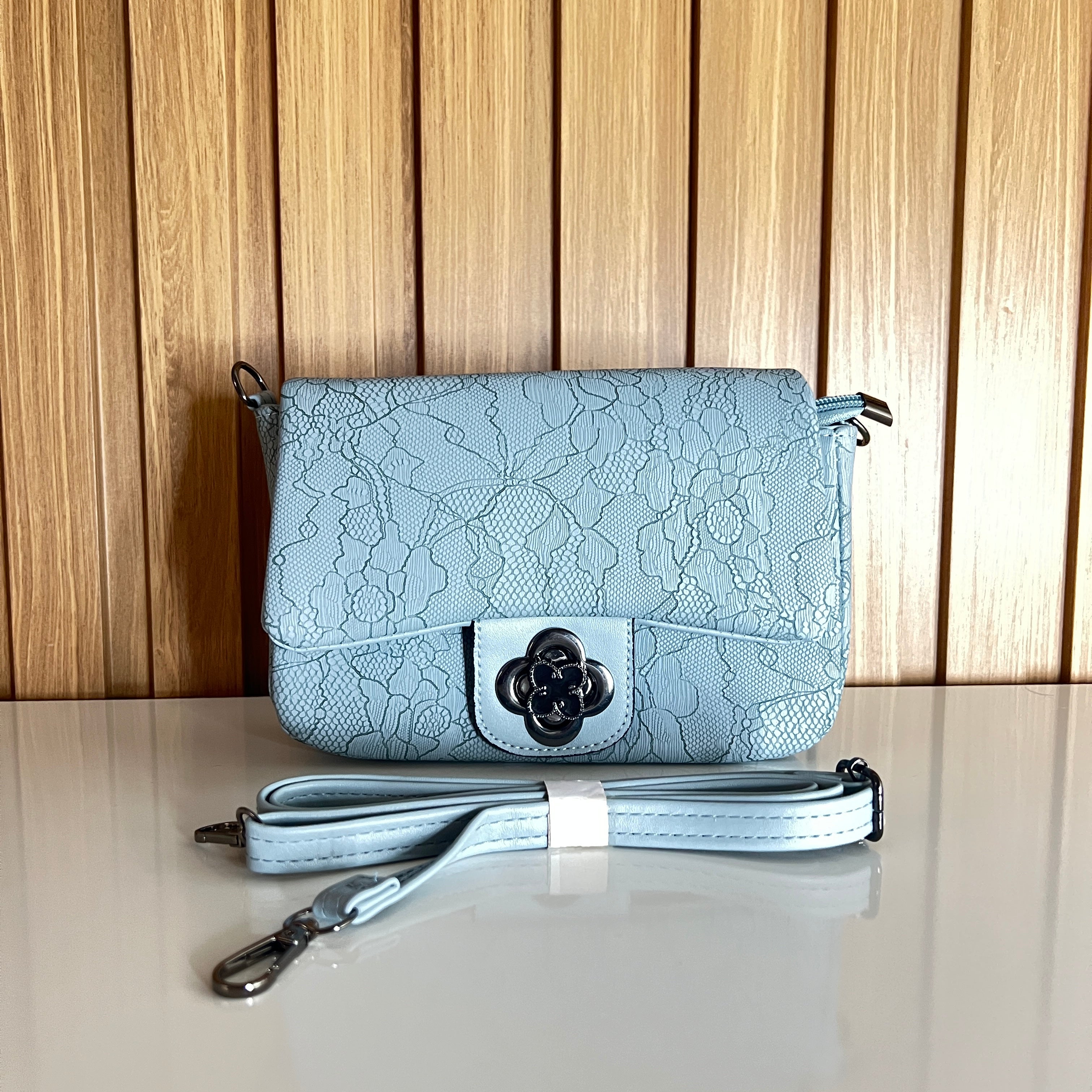 Powder blue floral crossbody bag front view with flower clasp and strap – Meraki by Emaan Pakistan