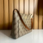 Side view of beige and brown women's monogram handbag