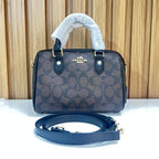 Signature Monogram Mini Barrel Bag – Brown & Black Top Handle & Crossbody Bag by Meraki by Emaan Pakistan - Front View with Strap