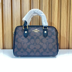 Signature Monogram Mini Barrel Bag – Brown & Black Top Handle & Crossbody Bag by Meraki by Emaan Pakistan - Front view