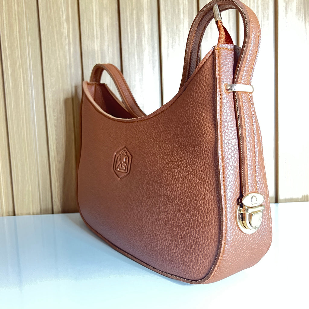 Tan hobo bag side view with gold push-turn lock clasp – Meraki by Emaan Pakistan