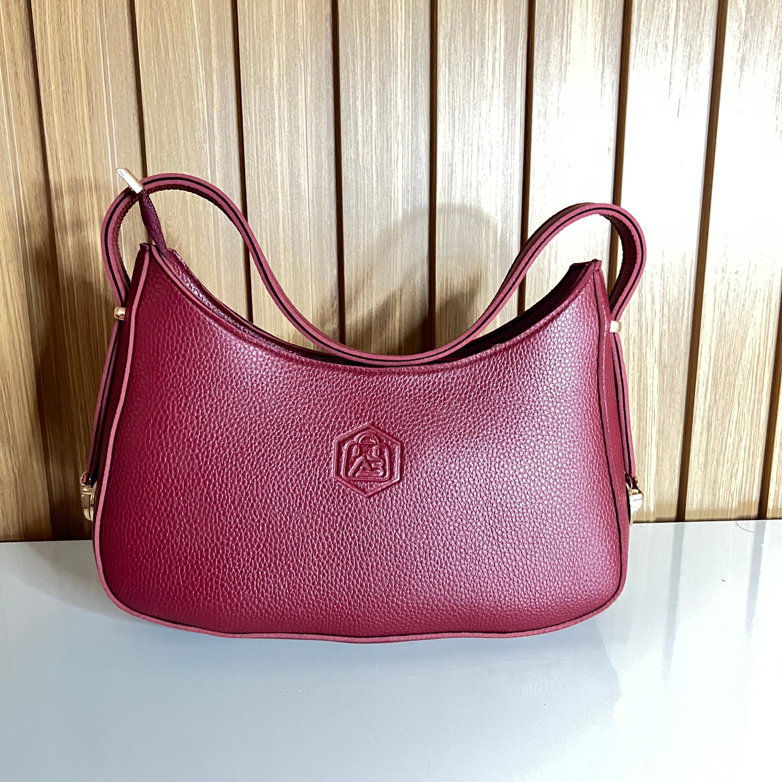 Wine red crescent hobo bag front view pebbled leather – Meraki by Emaan Pakistan