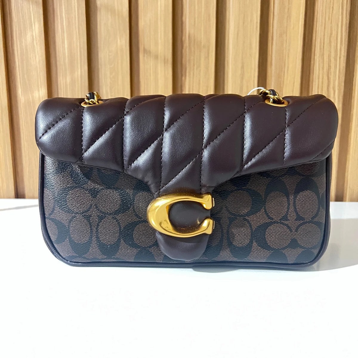 Black quilted shoulder bag with gold-tone clasp front view