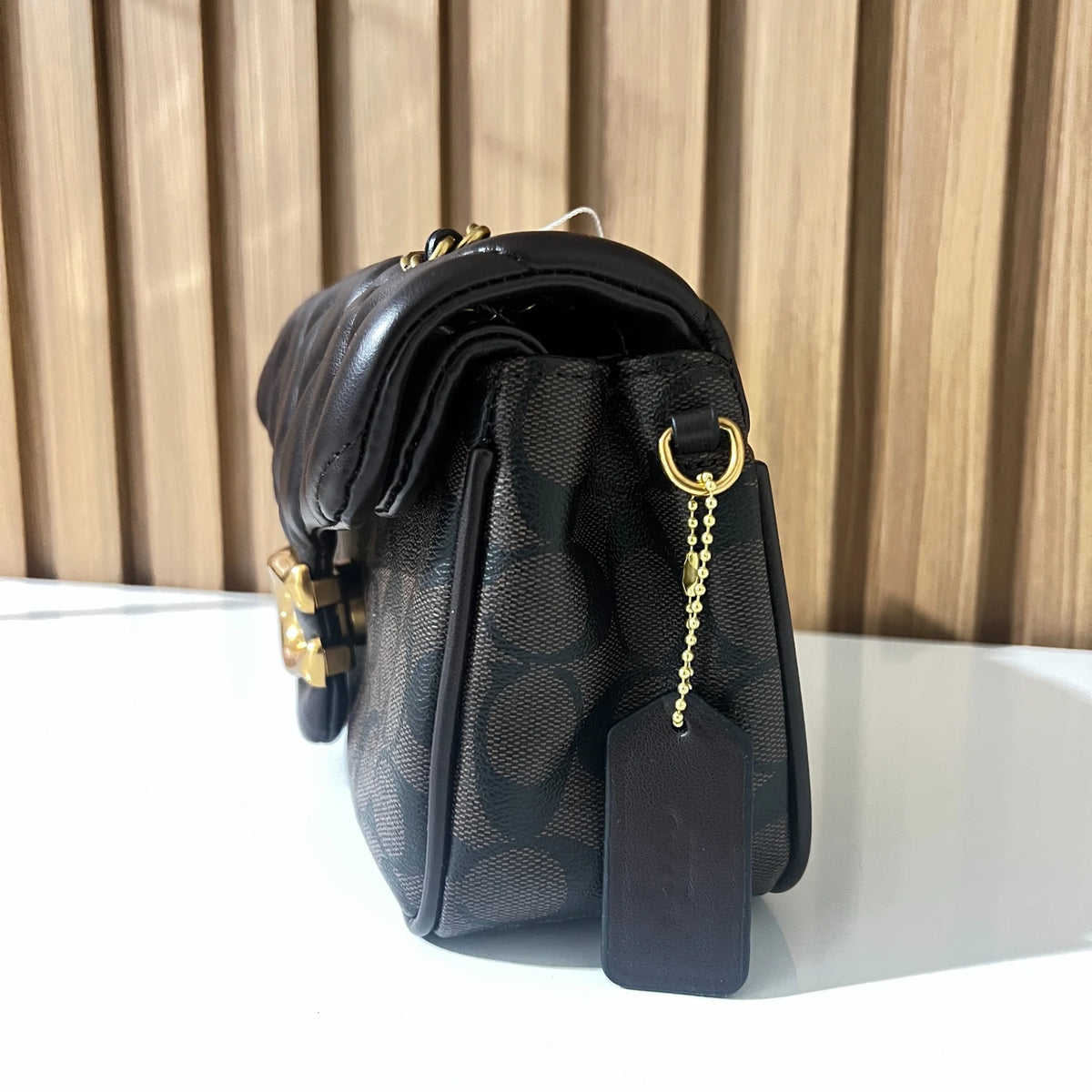 Black quilted chain shoulder bag side profile