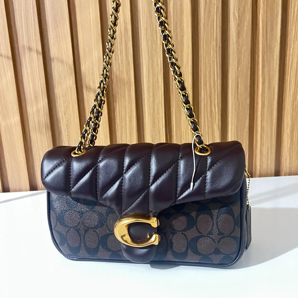Black quilted chain shoulder bag worn as shoulder bag