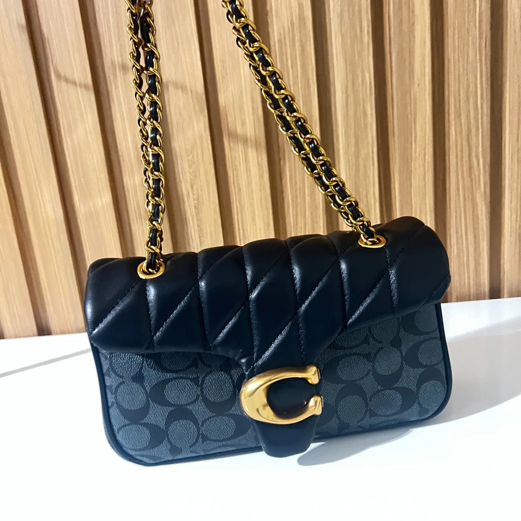 Black quilted chain shoulder bag for women angled view with gold chain strap
