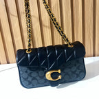 Black quilted chain shoulder bag for women angled view with gold chain strap