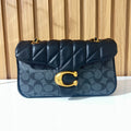 Black quilted chain shoulder bag for women front view with gold clasp