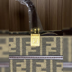 Close-up of gold-tone hardware and patterned fabric on tote bag
