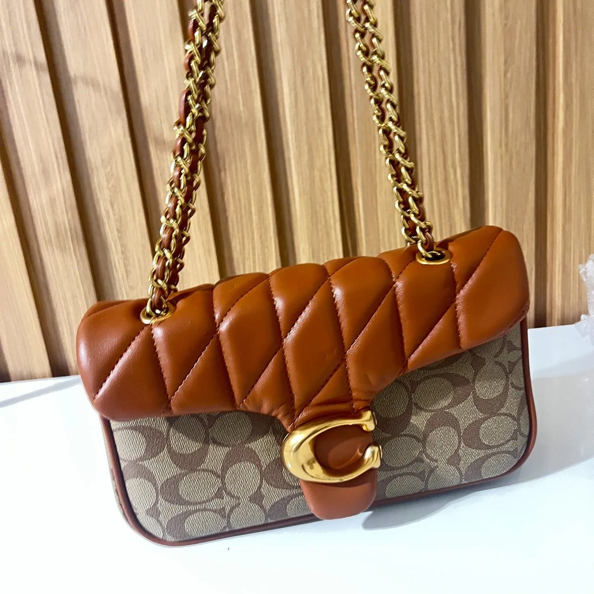 Cognac quilted chain shoulder bag for women angled front view