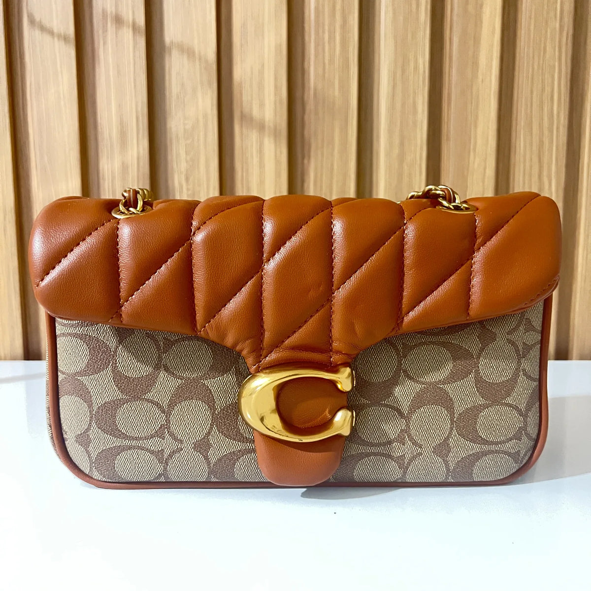 Cognac quilted chain shoulder bag for women front view with gold clasp