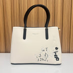 Cream black women's tote handbag front detail with floral embroidery