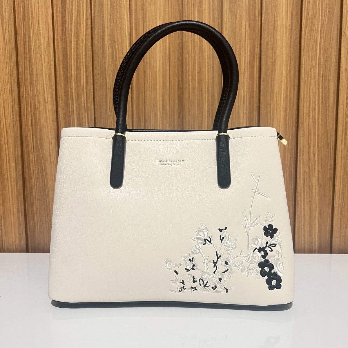 Cream black women's tote handbag front detail with floral embroidery