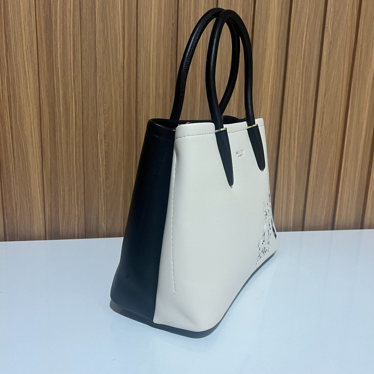 Cream and black embroidered tote handbag side profile